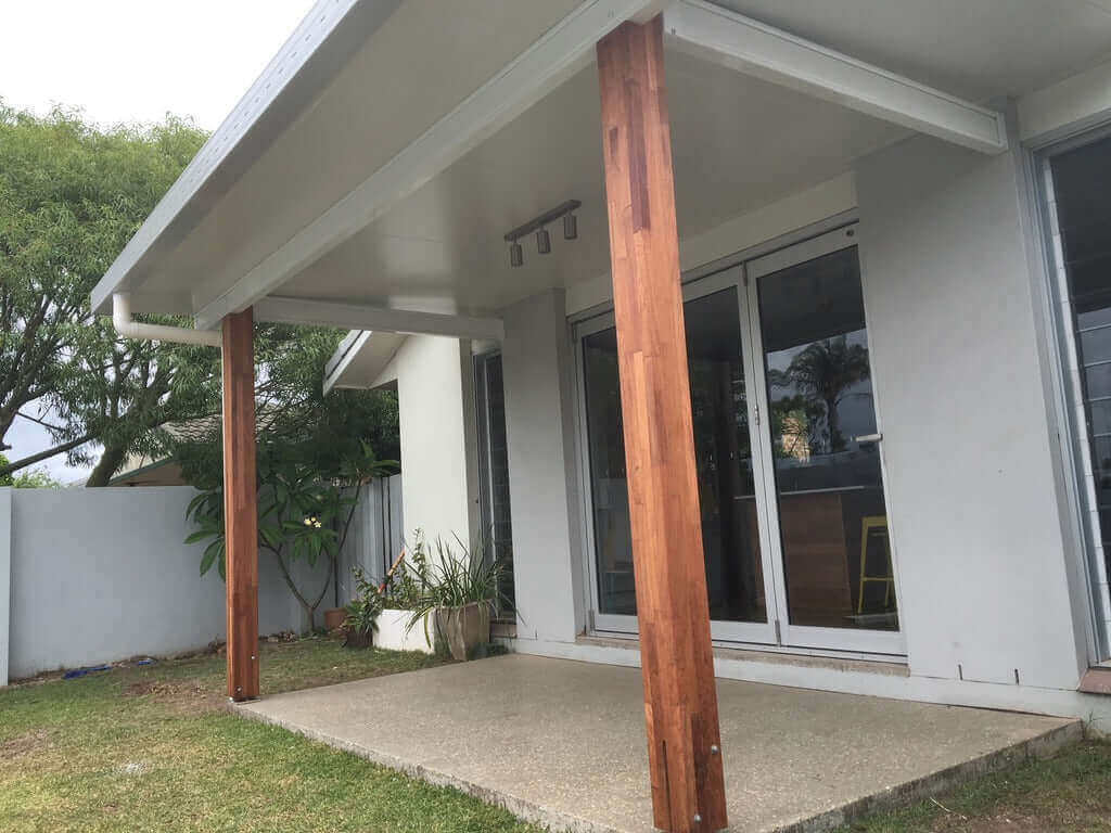 Stylish insulated patio with elegant timber posts, featuring built-in downlights for ambient evening lighting perfect for outdoor living and entertaining.