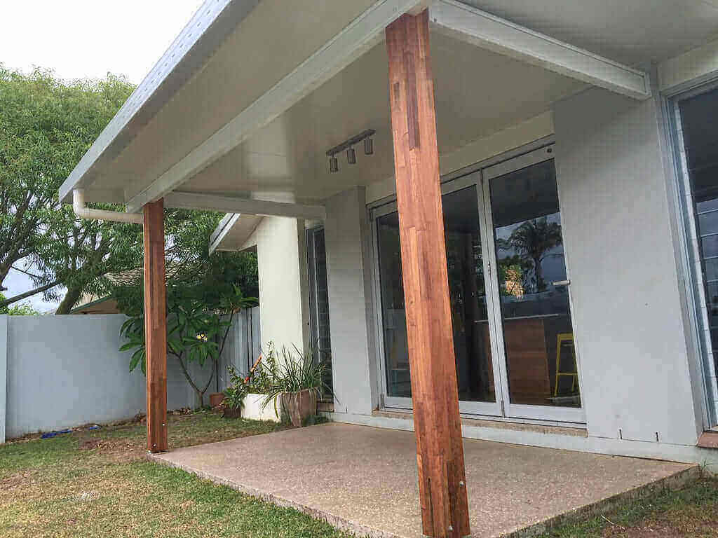 Insulated skillion patio roof with timber posts, providing a modern covered outdoor living area attached to a residential home.