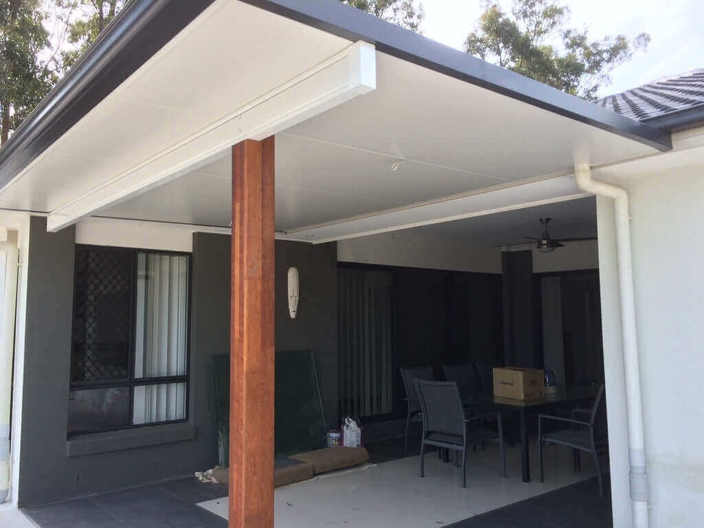 Stylish insulated patio with elegant timber posts, featuring built-in downlights for ambient evening lighting perfect for outdoor living and entertaining.