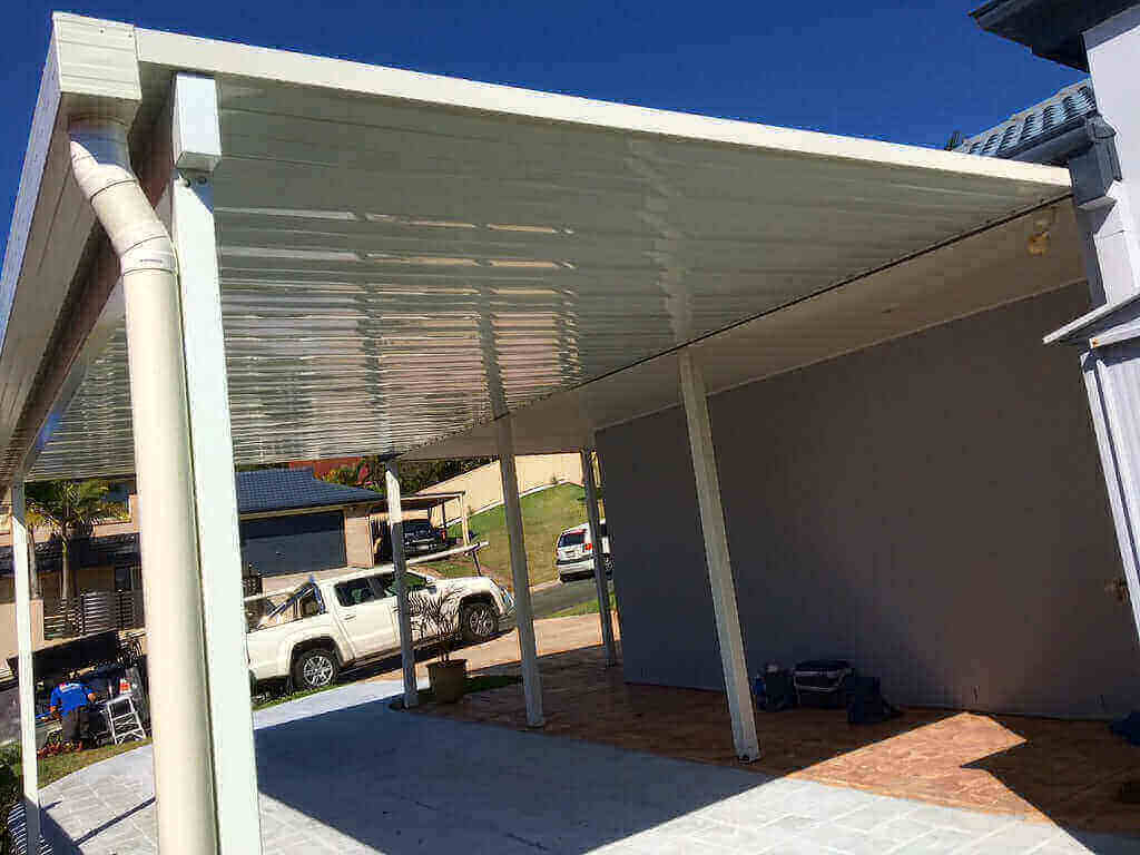 Durable single-skin patio roof anchored to a sturdy slab, with a company truck parked beneath and a bright blue sky overhead, ready for outdoor gatherings.