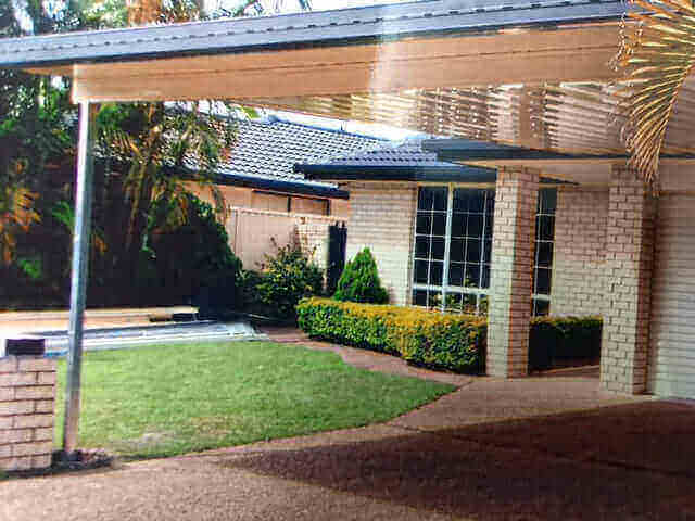 Single-skin patio with extended roof over a landscaped backyard, creating a shaded outdoor space ideal for entertaining and relaxation.