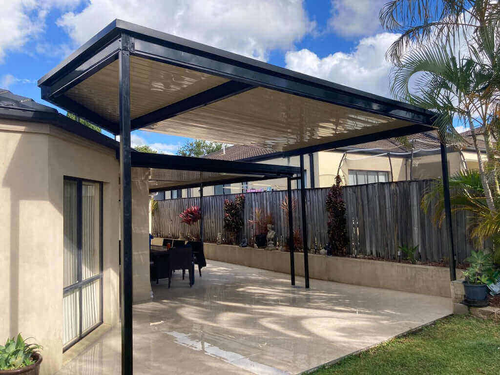 Dual-section patio roof designed to blend with the home, featuring cream-colored undersides for cohesive outdoor aesthetics.