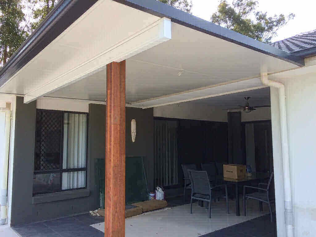 Insulated skillion patio roof with timber posts, providing a modern covered outdoor living area attached to a residential home.