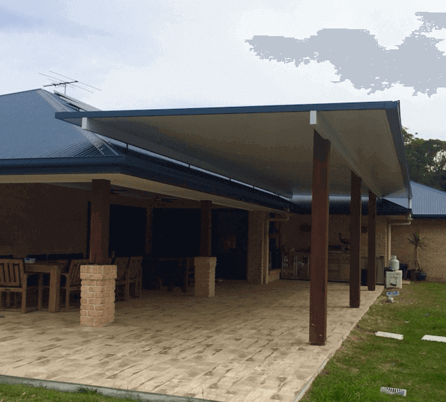 Insulated patio roof fixed with large timber posts, with tiled area and outdoor furniture and decor with feature stone pillar posts connected to home.