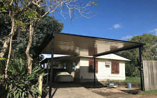 Free-standing single-skin patio carport, built to last in a residential setting, providing durable protection for vehicles and outdoor spaces.