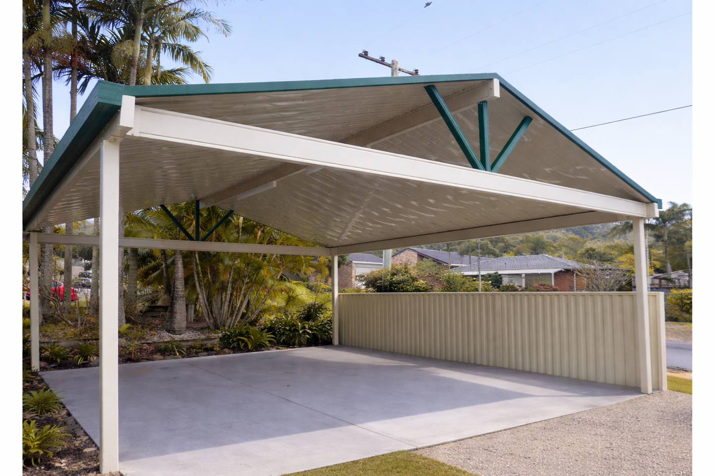 Gable-roof carport with a white frame and green trim for that pop of colour. Installed over a concrete slab. Supported by 4 posts and durable beems - keeping it sleek and a neighbourhood standout
