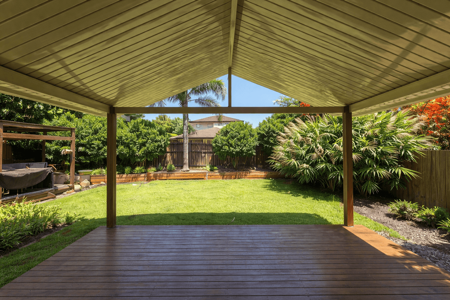 Gable-style patio roof with a pitched metal design - structured support for durable overhead coverage with a stylish finish.
