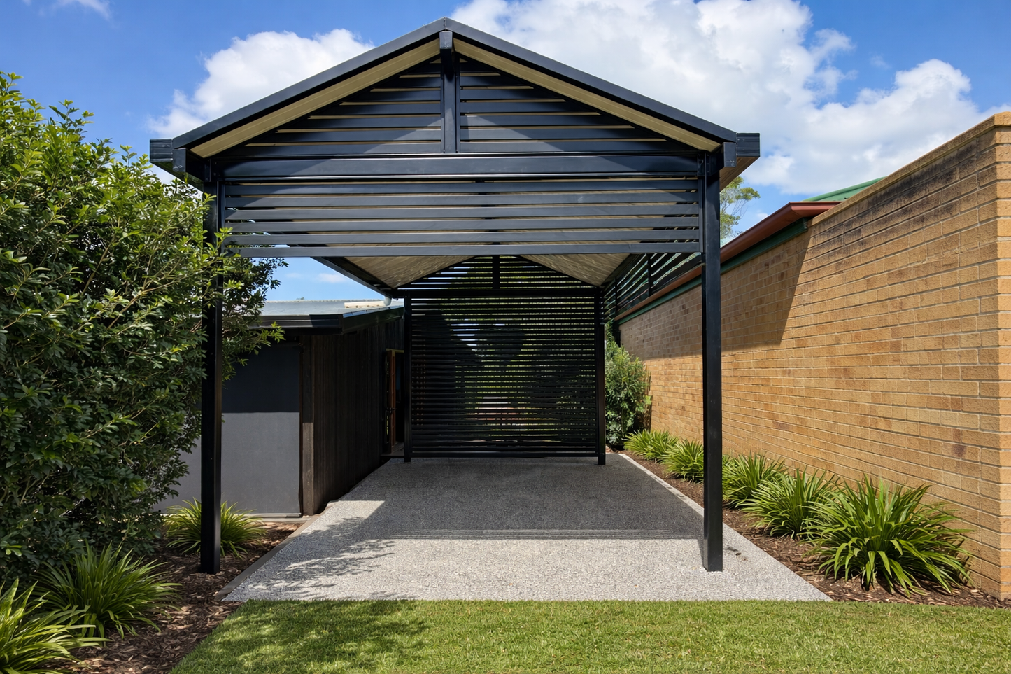 Modern gable carport with a black steel frame and slatted side panels, featuring a pitched metal roof for covered vehicle protection whilst providing a personalised style.