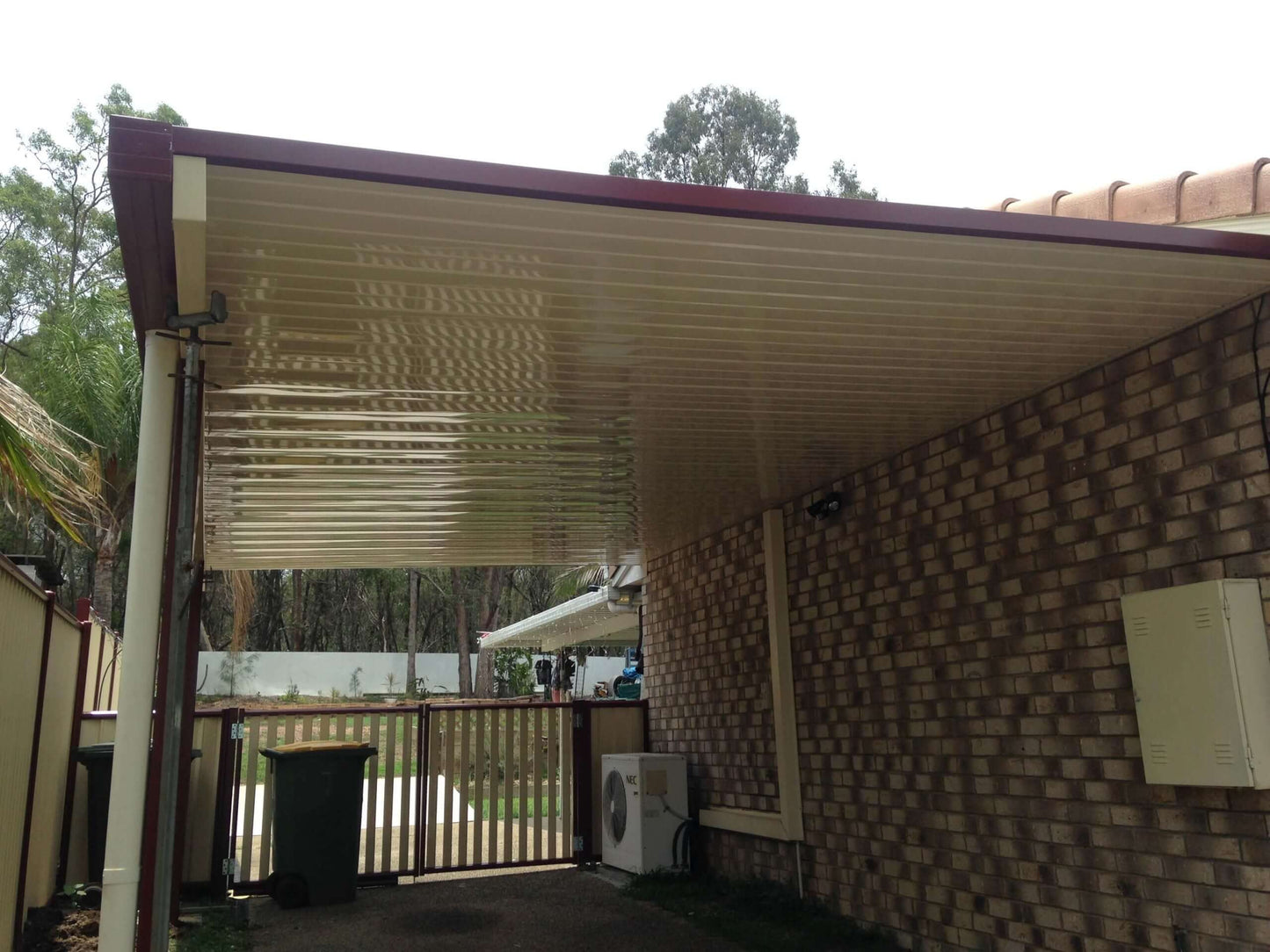 Single skin DIY V-Line Patio Carport Attached To Masonry with steel posts, providing durable patio roofing and covered outdoor living space for an Australian home.