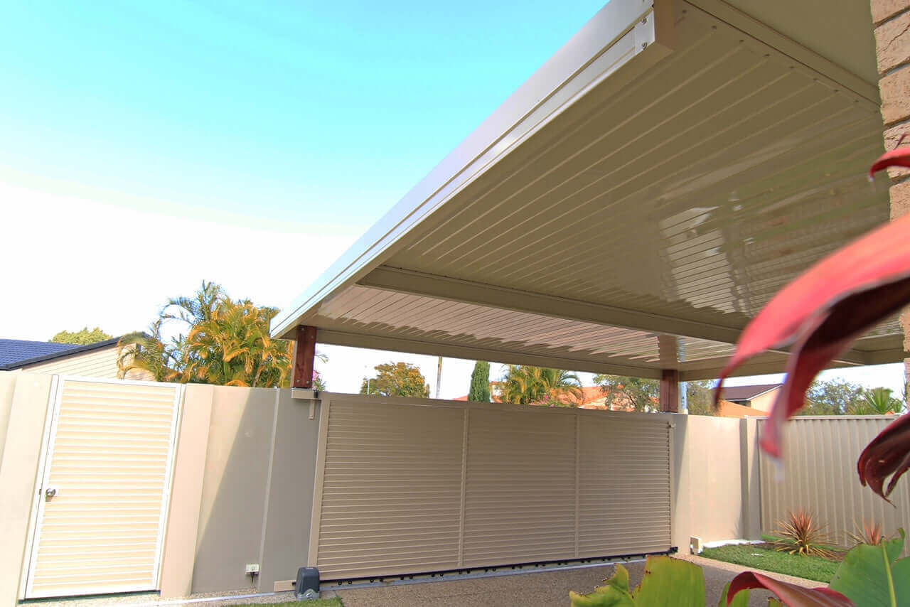 Single skin patio roof attached to a house wall, providing shaded outdoor space with a simple and durable steel design.
