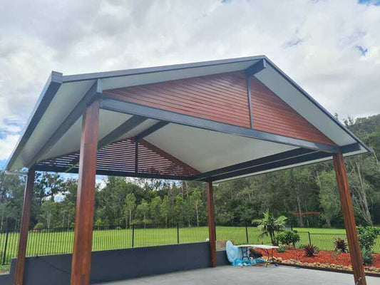 Stylish wooden DIY carport design with a gabled roof, ideal for enhancing outdoor spaces.