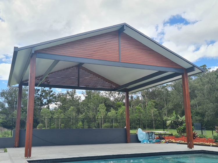 "Free Standing Gable Patio Or Carport kit with pitched roof and timber posts in Australian backyard"