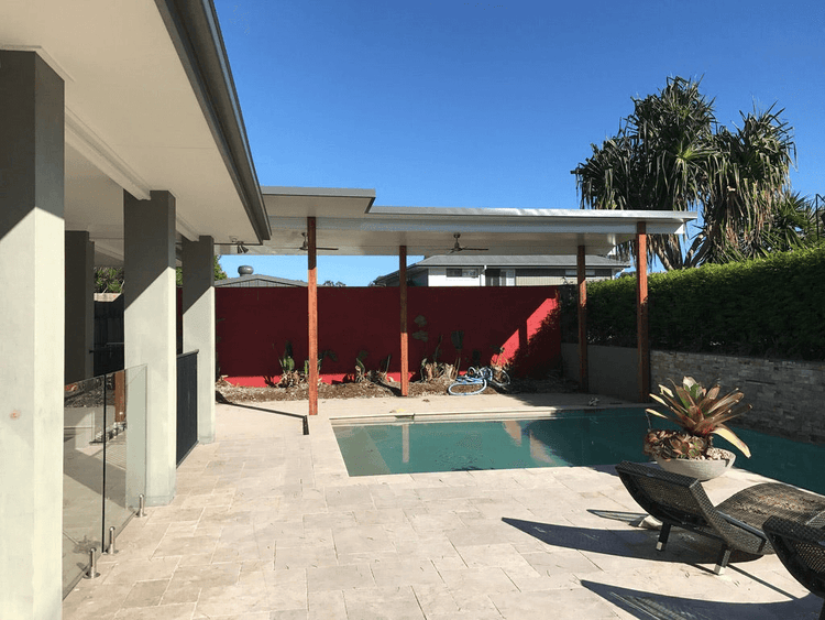 DIY Free Standing Trimdek Insulated Carports or Patios overlooking a serene pool area with modern architecture.