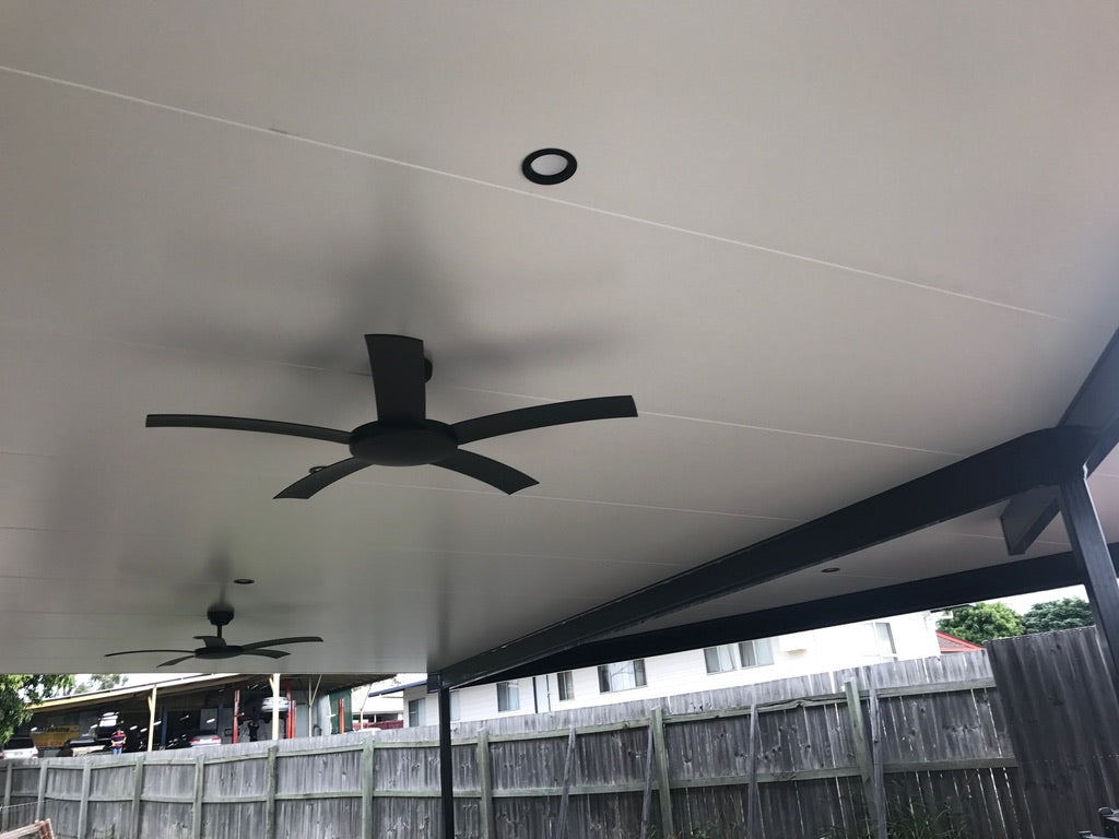 Inside view of a  Insulated Patio Carport Attach Timber Fascia with modern ceiling fans.