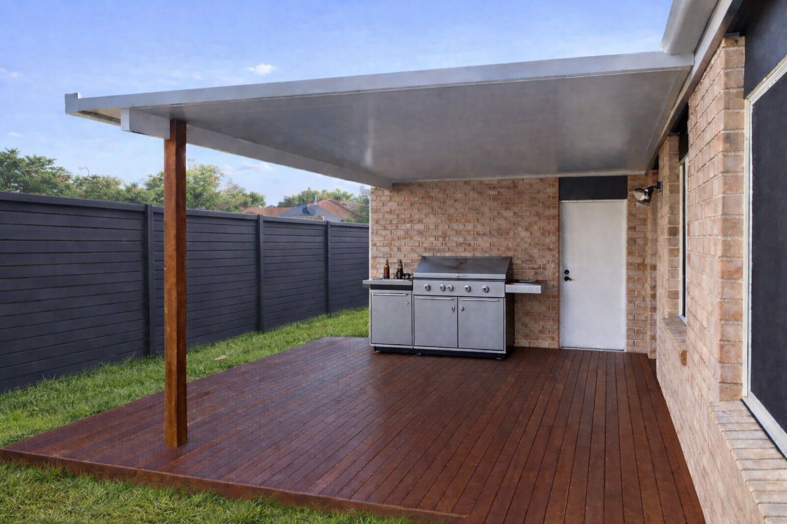 Insulated patio roof extending over a timber deck, fixed to timber 
