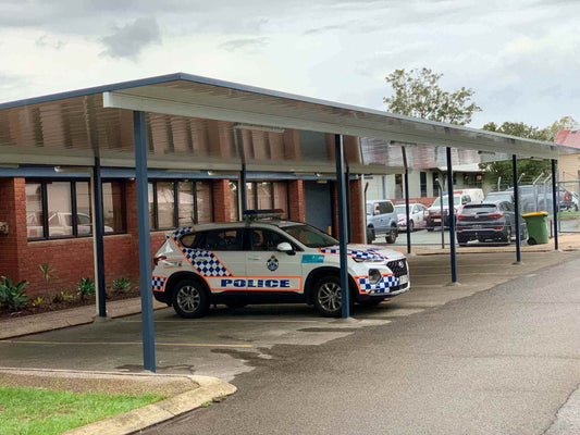 V-Line single skin free standing patio/carport installed in a commercial police station setting, providing reliable weather protection for fleet vehicles.