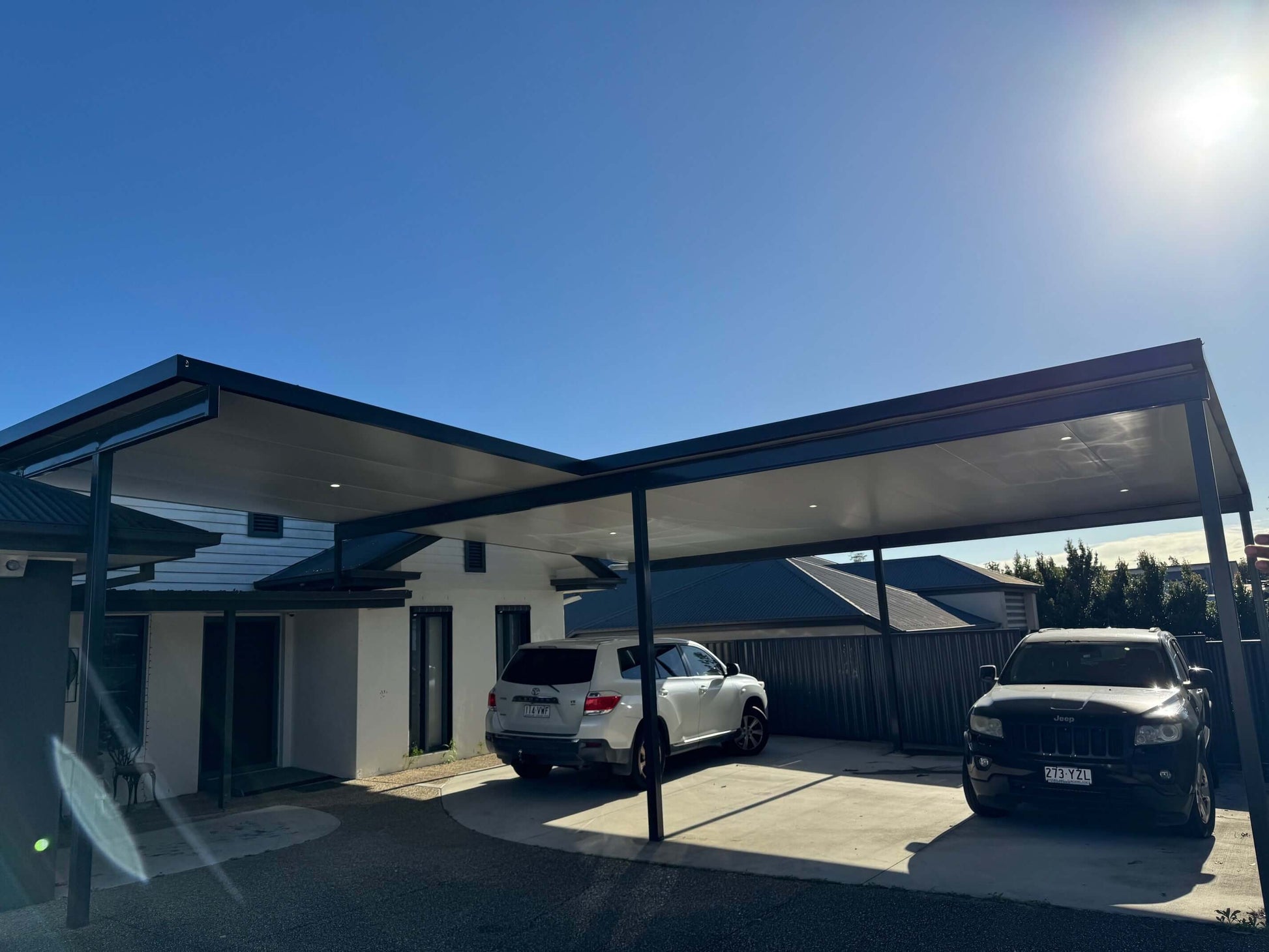 Insulated flyover carport designed to accommodate two cars, combining weather protection, convenience, and lasting value for homeowners.