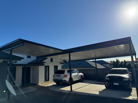 Insulated flyover carport designed to accommodate two cars, combining weather protection, convenience, and lasting value for homeowners.