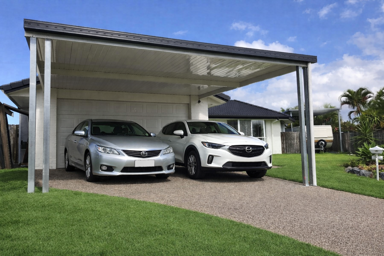 Single skin V-Line carport roof attached to the house with steel posts, delivering a strong, low-maintenance carport roofing solution that provides reliable weather protection, a clean modern finish, and practical covered driveway access ideal for Austral